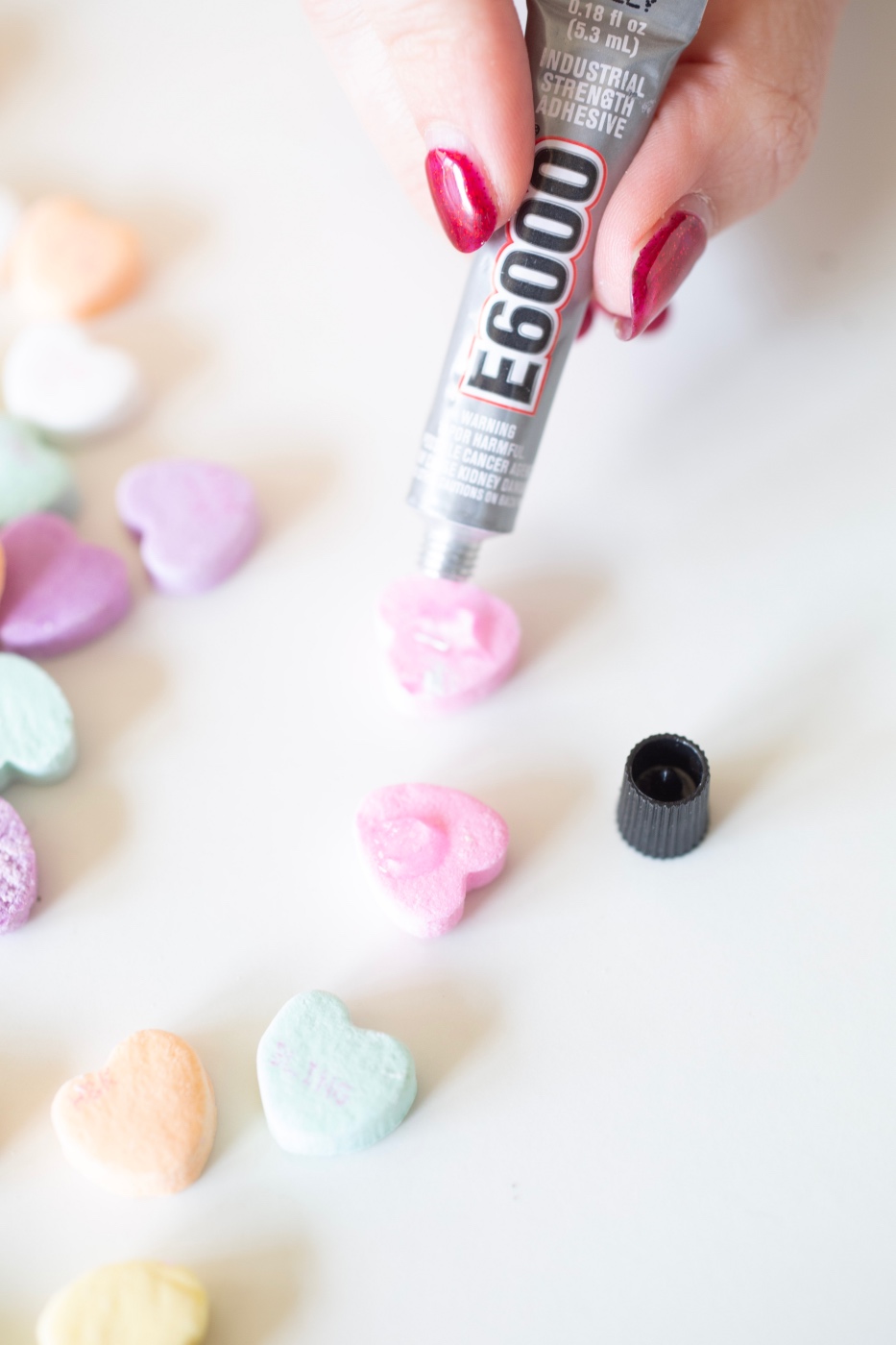 add the glue to the conversation heart to make diy candy earrings