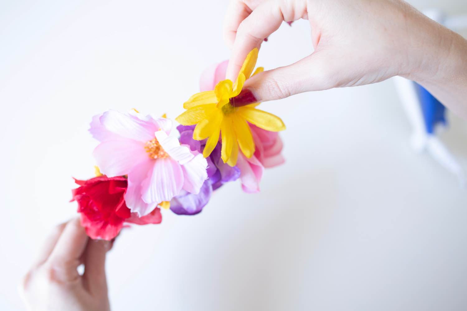 adding large and small flowers to make a diy flower crown