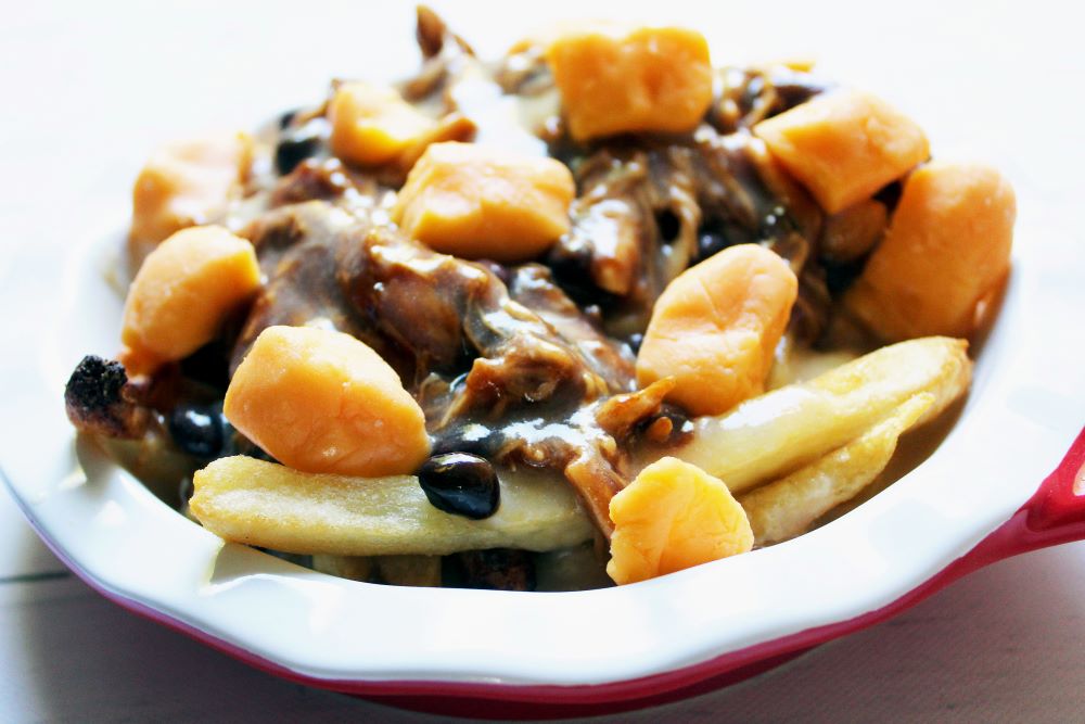 angled view of bbq chicken black bean poutine