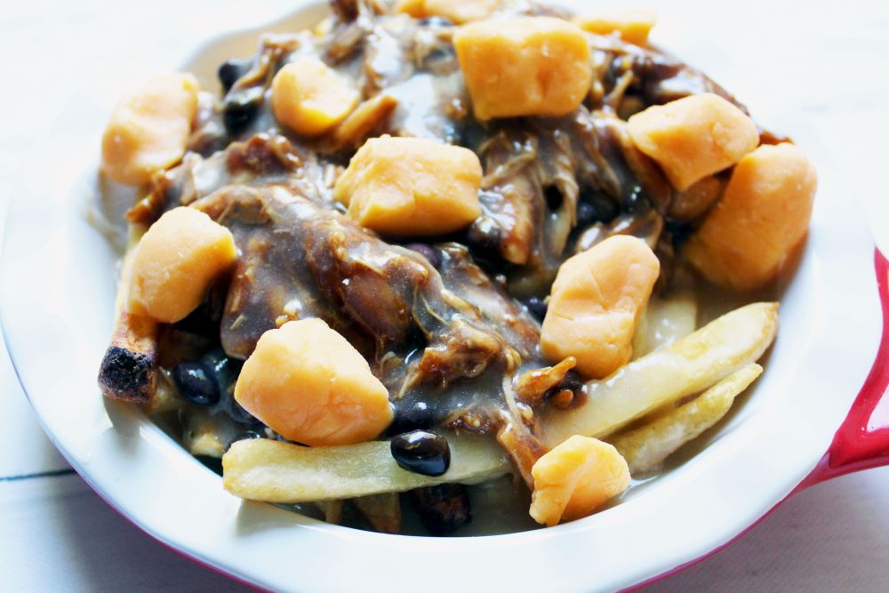 bbq chicken black bean poutine topped with cheese curds