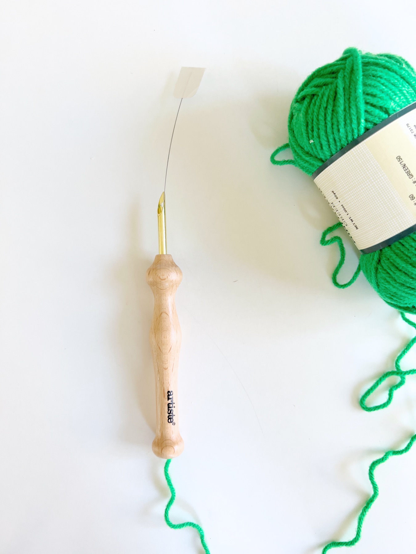 pull the yarn through the punch needle tool