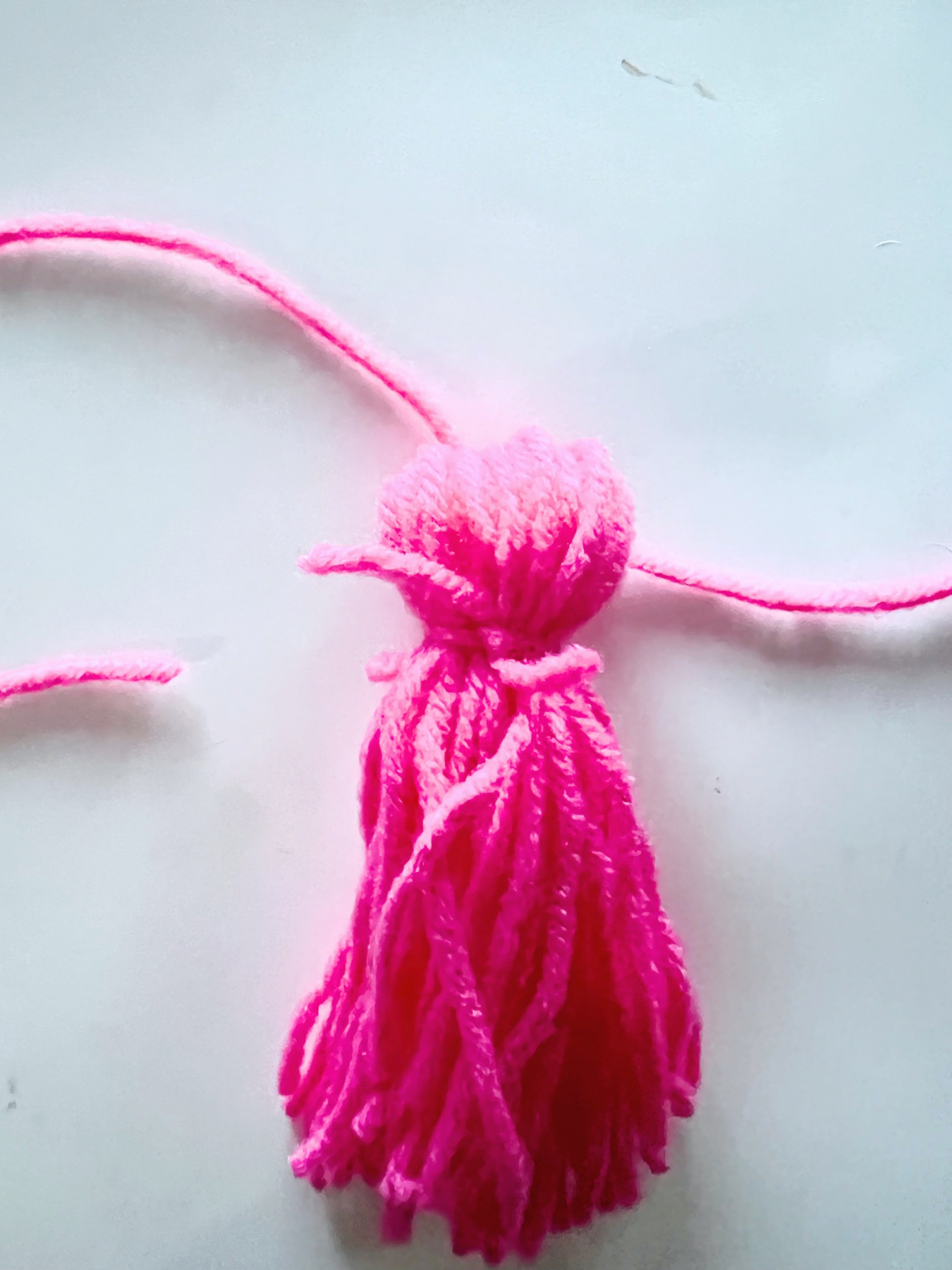 tie a second knot to make a diy yarn tassel