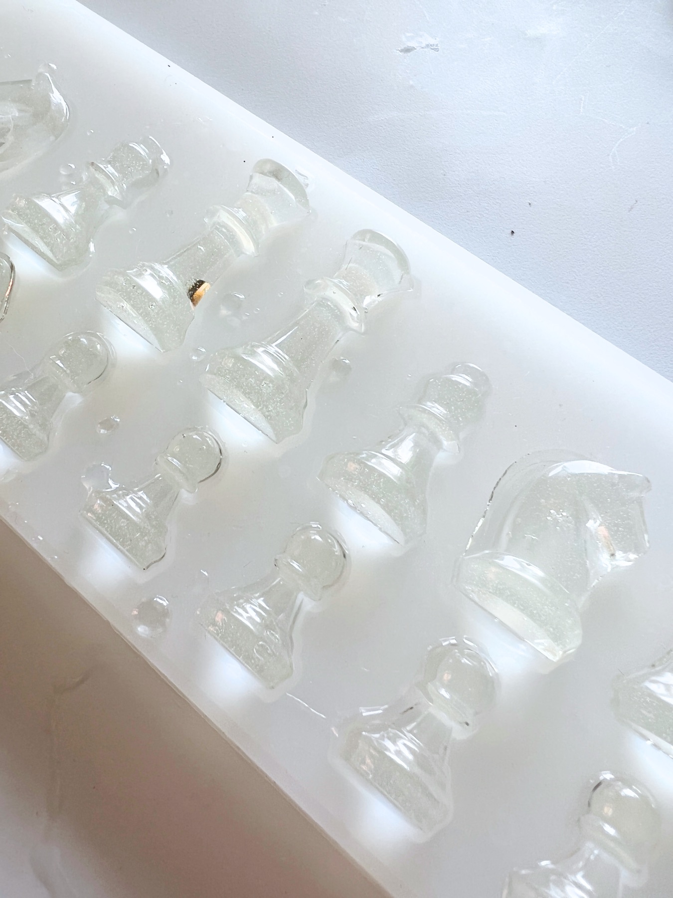 place the chess pieces on liquid resin in the mold