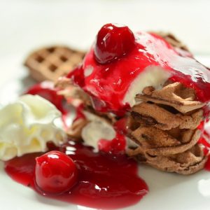 stack of homemade cherry cheesecake waffles with graham crackers