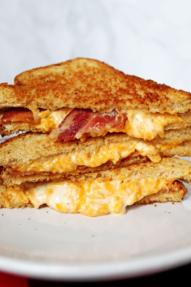 3 stack on plate of bacon cheddar ranch grilled cheese 1