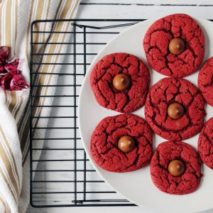 red velvet cherry kiss cookies on plate on cooling rack 1