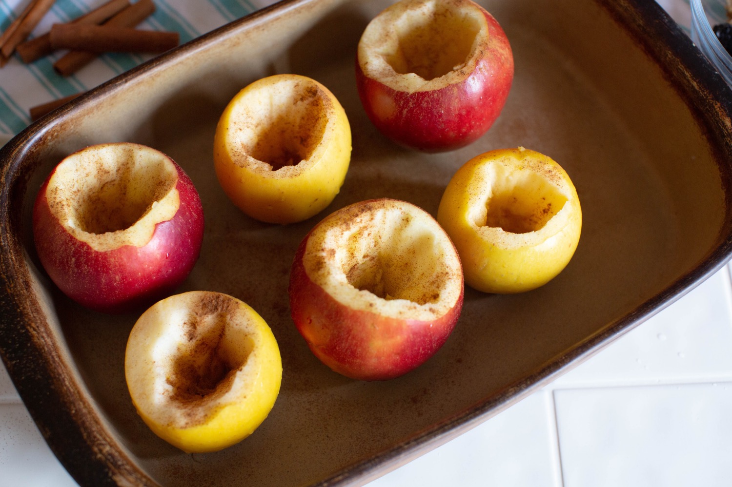 sprinkle hollow baked apples with cinnamon