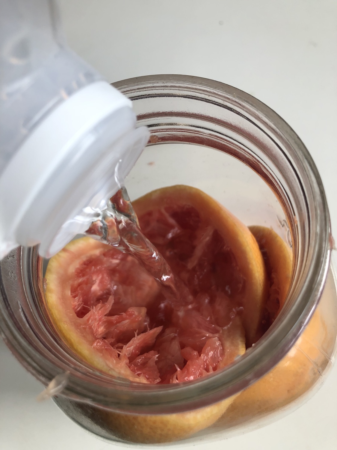 citrus vinegar all purpose cleaner spray pouring white vinegar into glass jar
