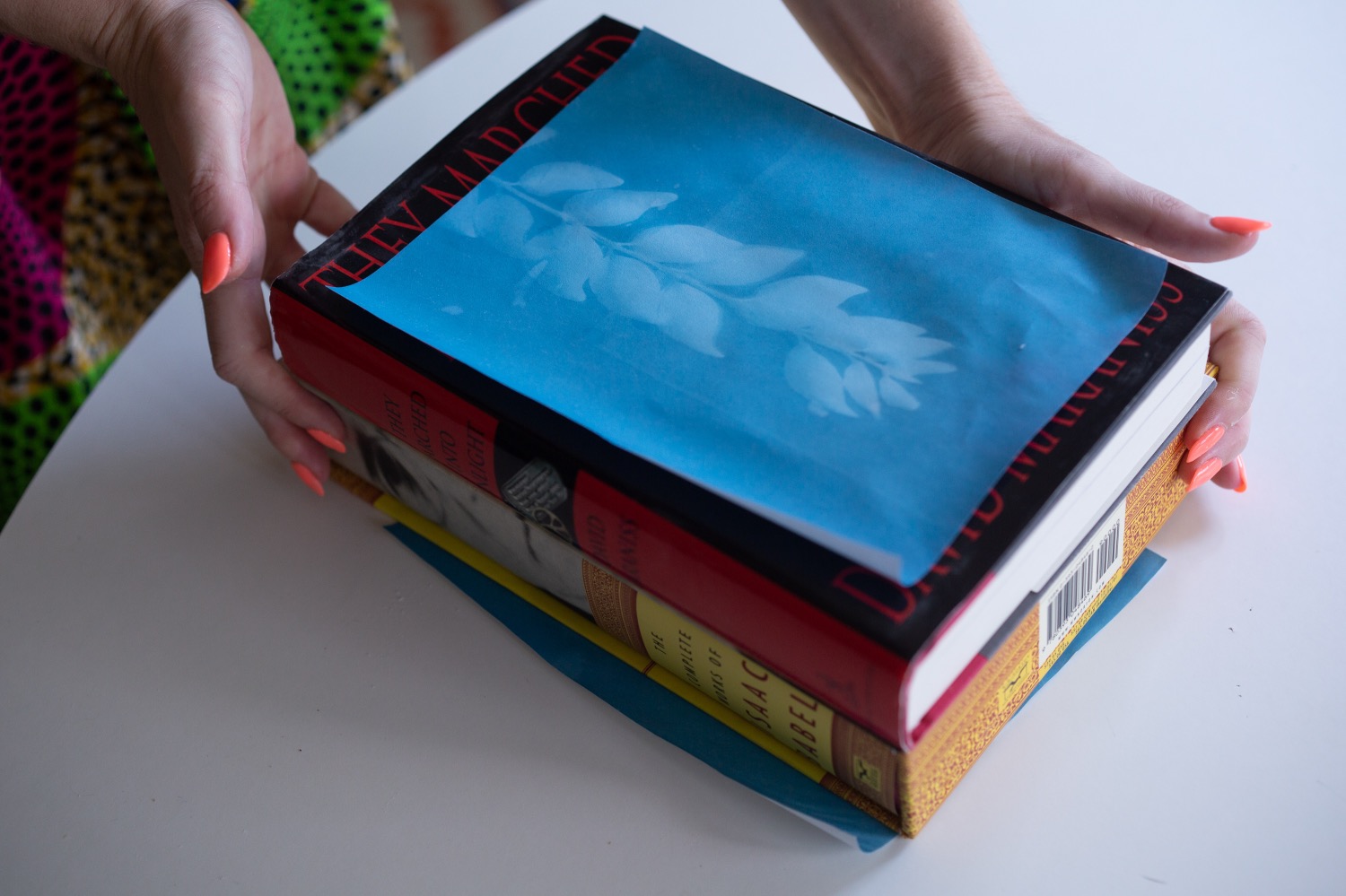 flatten photo paper by placing it underneath books