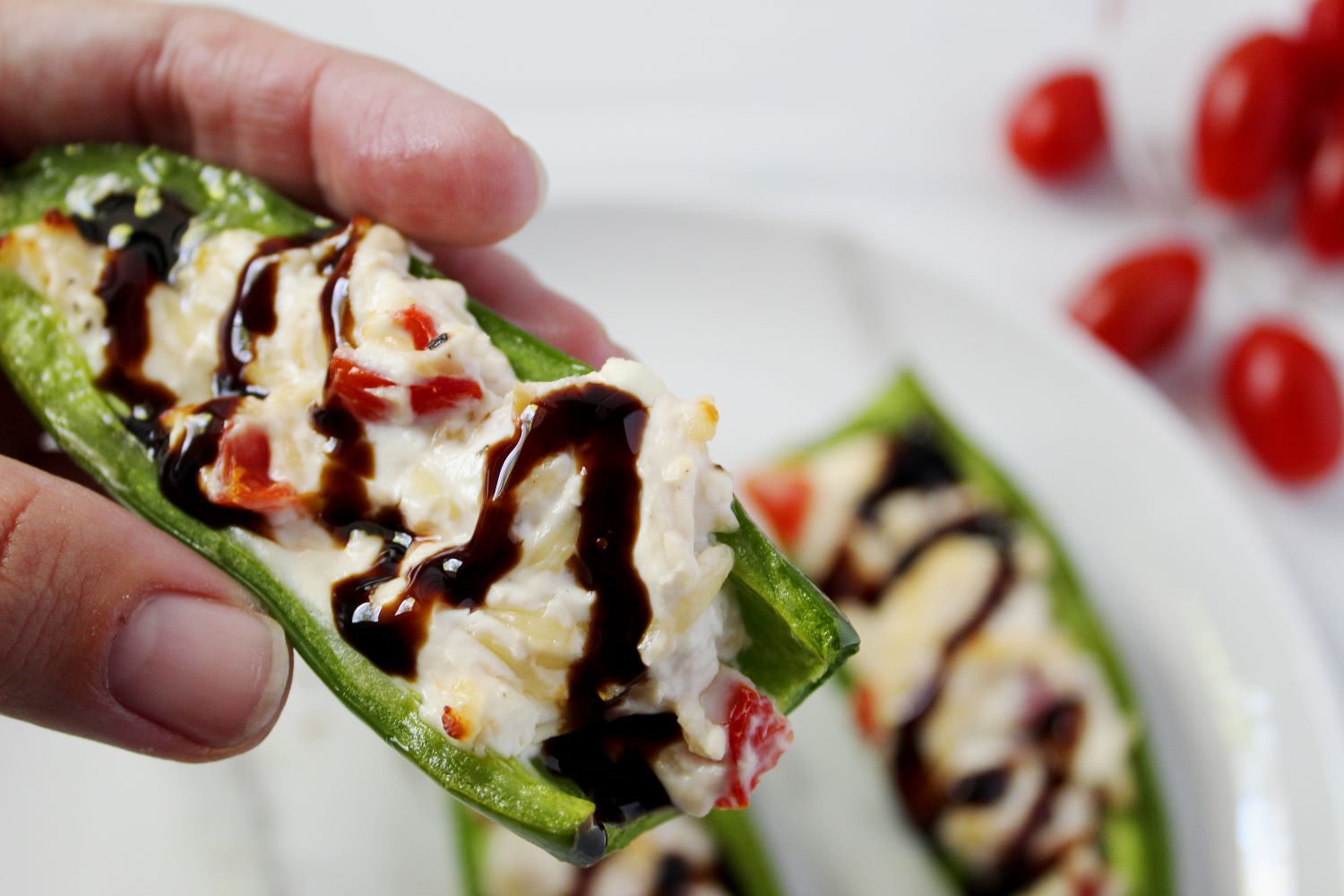 hand holding air fryer stuffed jalapeno half 1