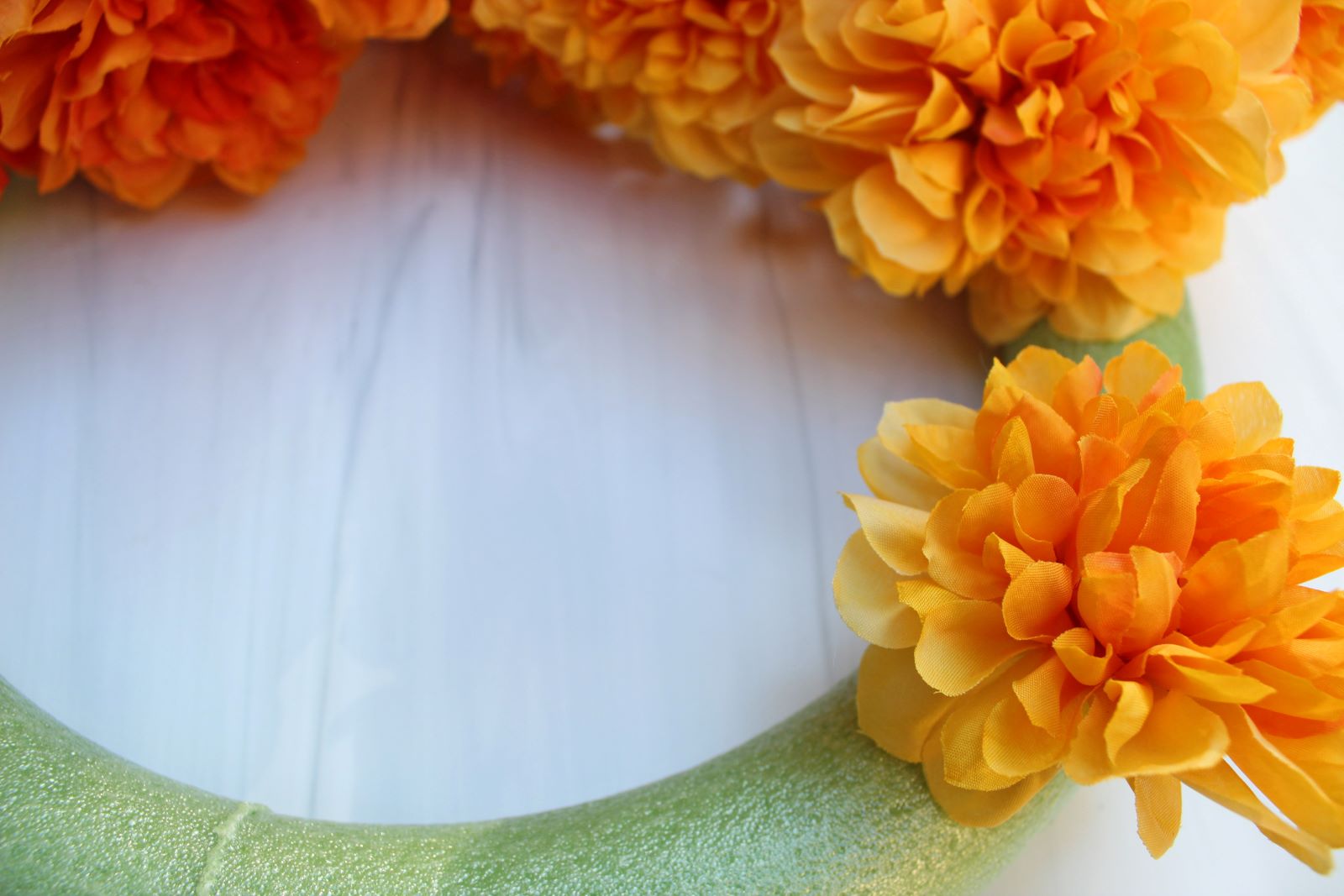 sticking flower stem into foam wreath ring 1