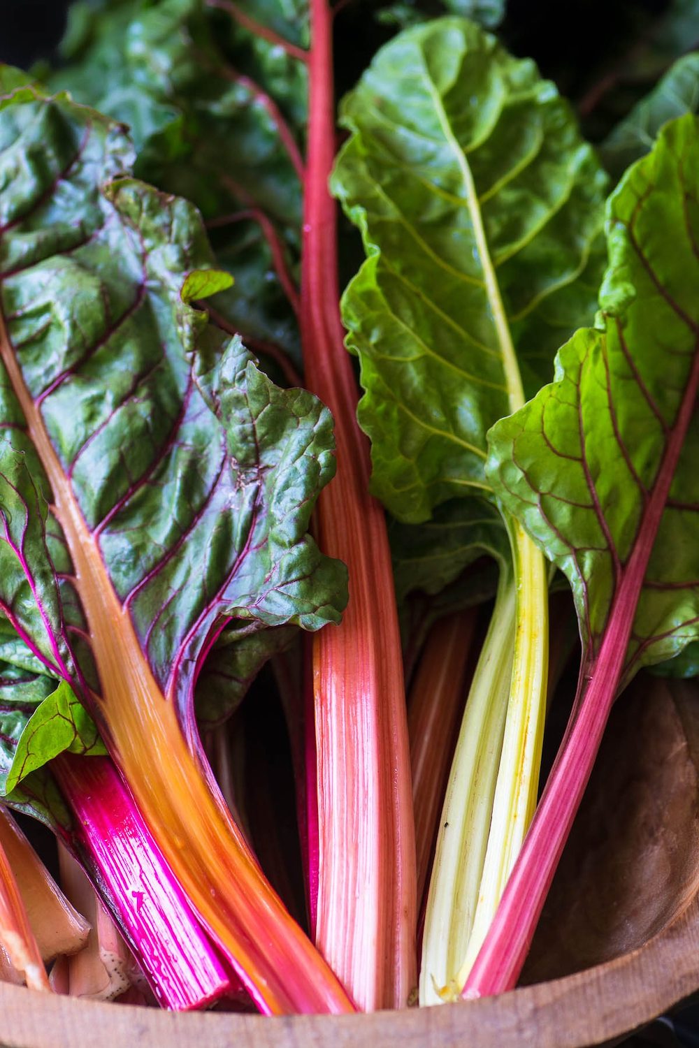 rainbow chard stems and greens in a wooden bowl