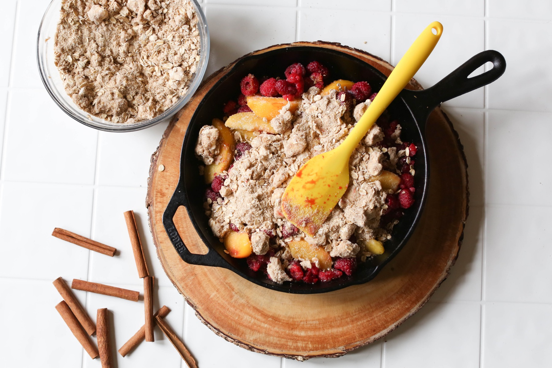 add the crisp topping to the raspberry and peach crisp