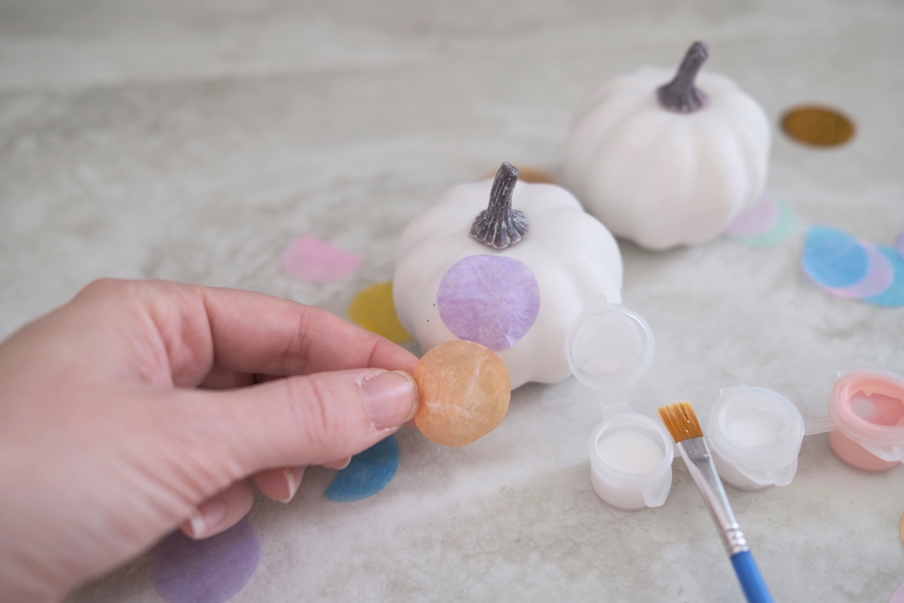 adding tissue paper to make confetti pumpkins