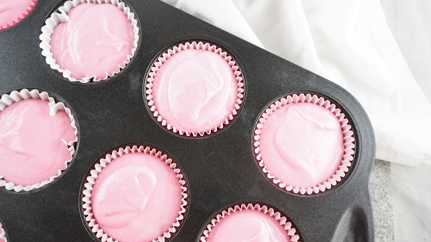 pink champagne cupcake batter in liners