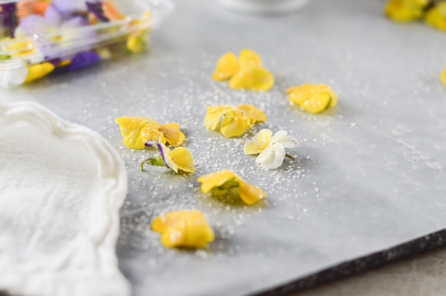 drying candied flowers on parchment