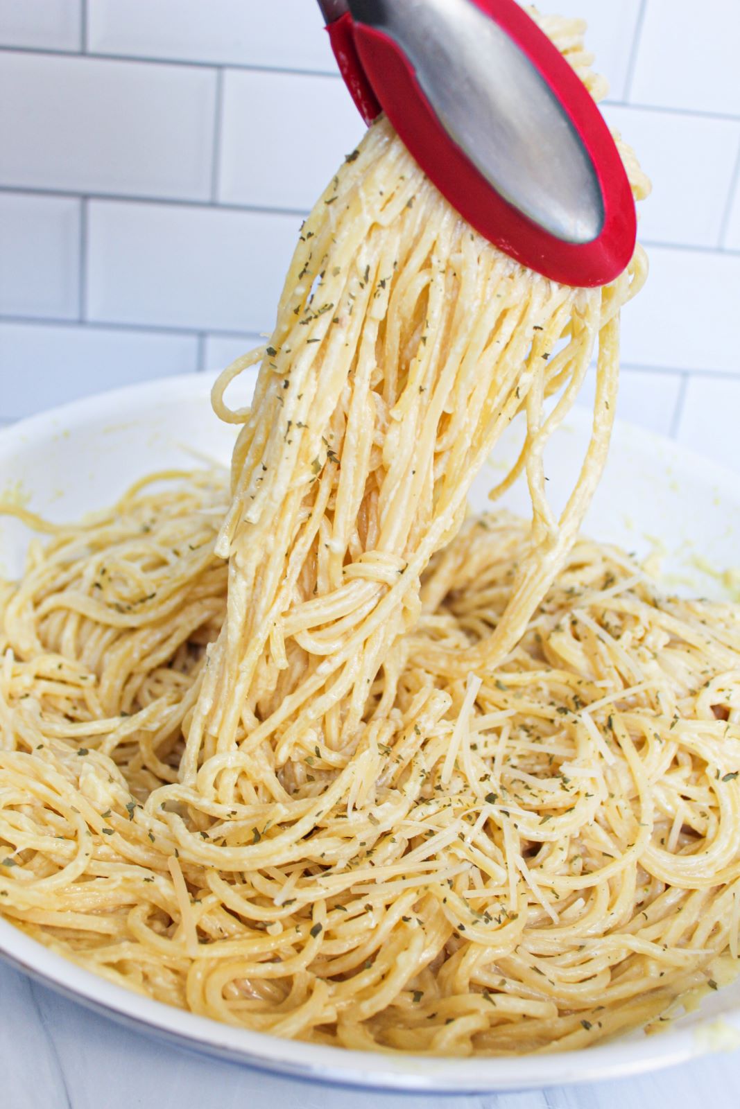 lemon garlic parmesan pasta being lifted out of skillet 1