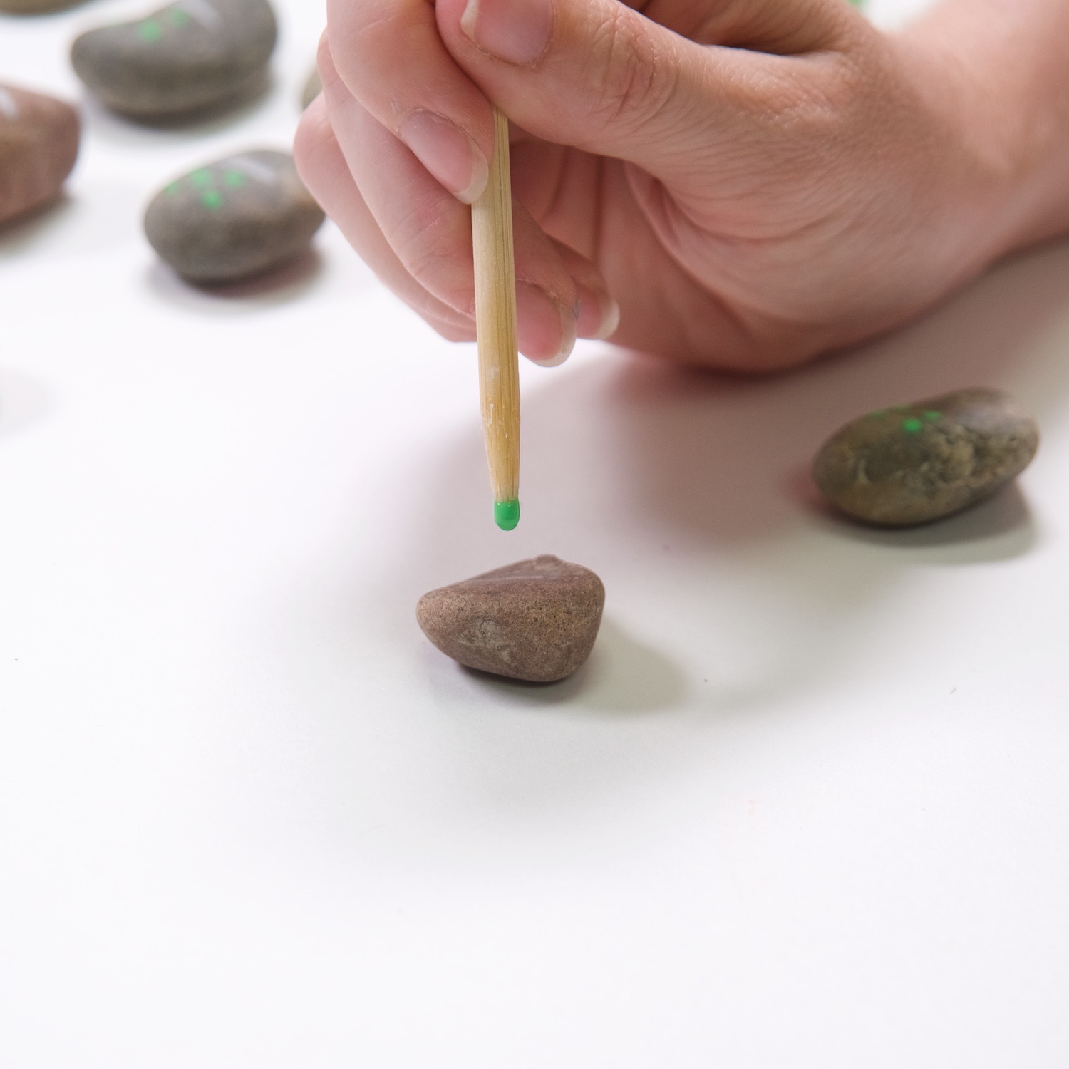 paint dots with a wood skewer to make rock dominoes