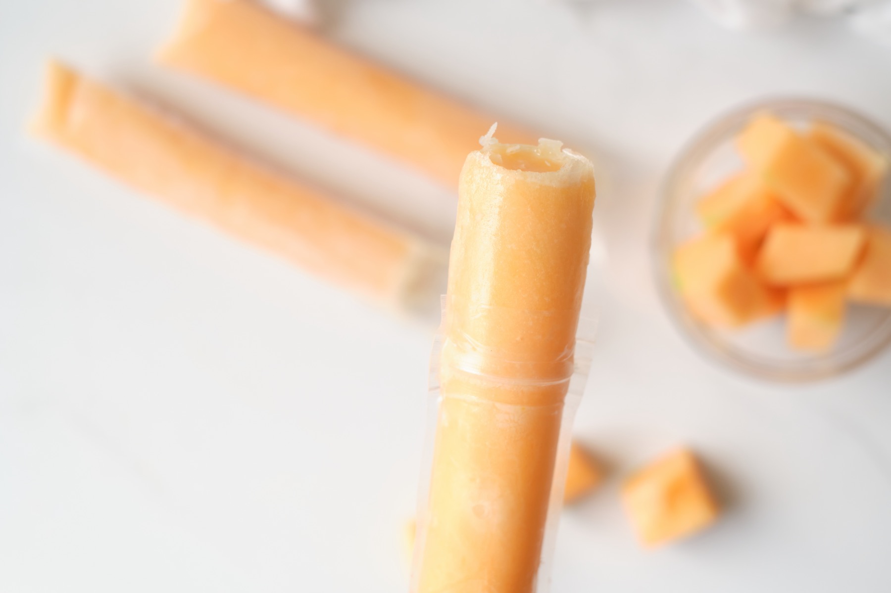 https://popshopamerica.com/wp-content/uploads/2021/07/close-up-of-the-no-sugar-added-cantaloupe-popsicles.jpg