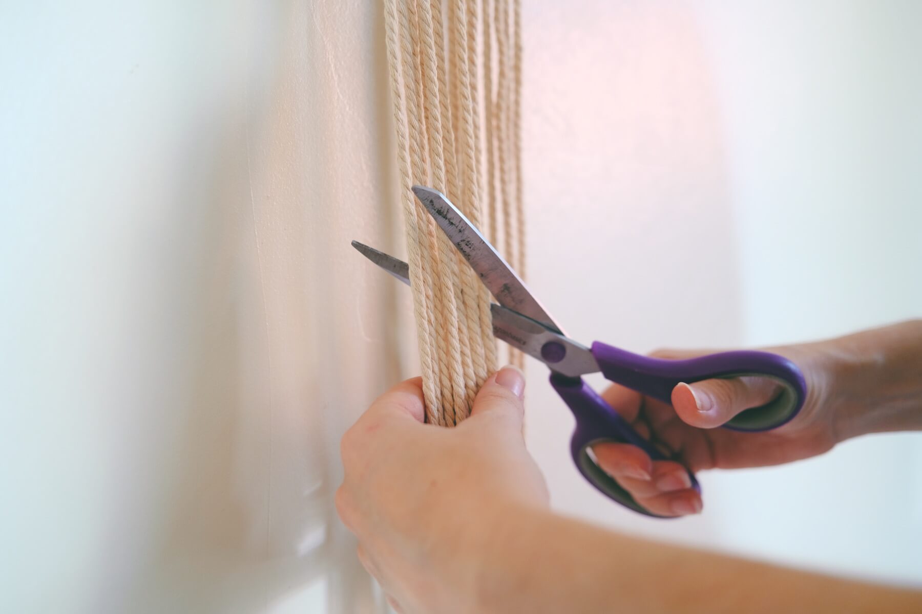 trim the ends of the macrame wall hanging