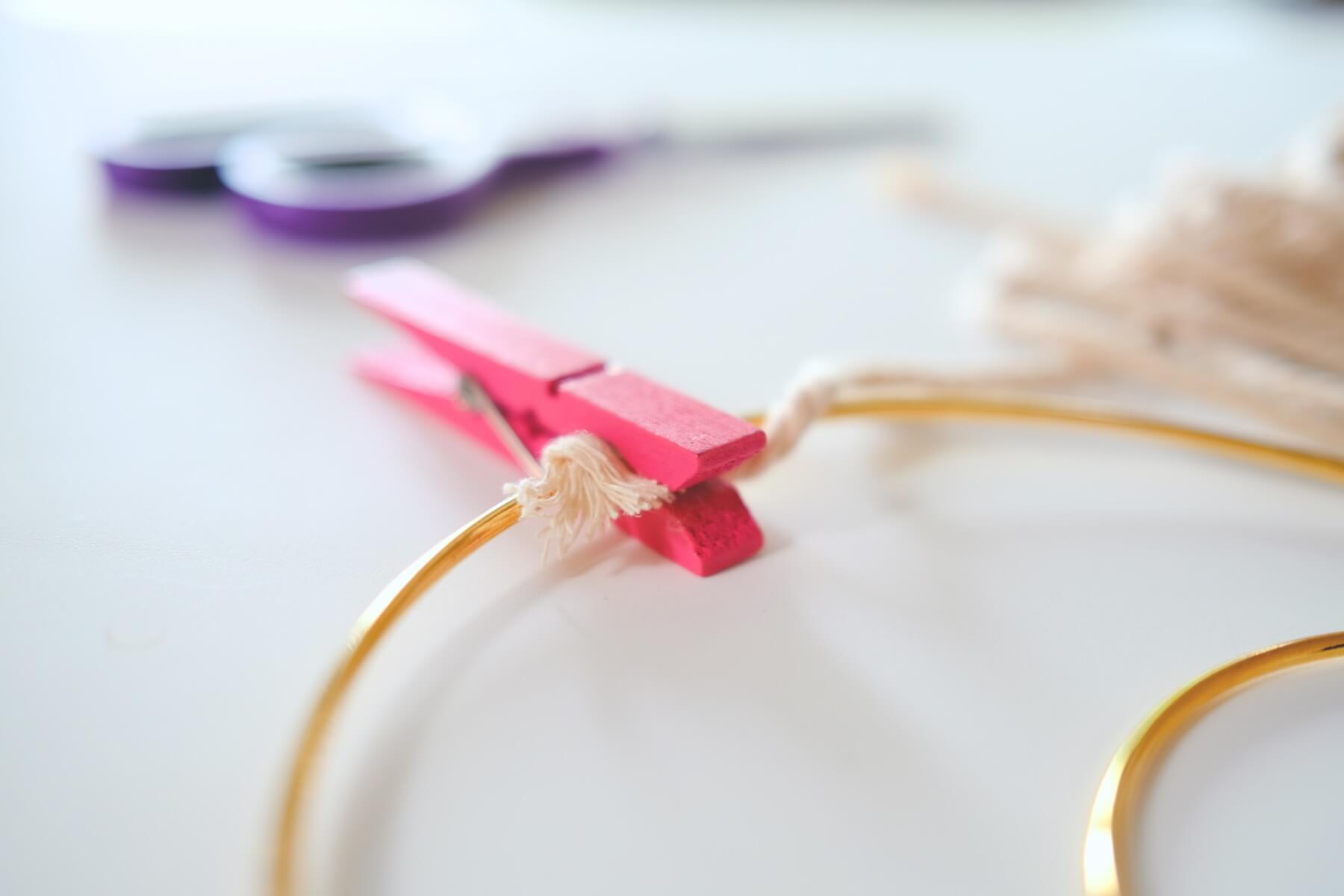 use a clothespin to hold the macrame cord in place
