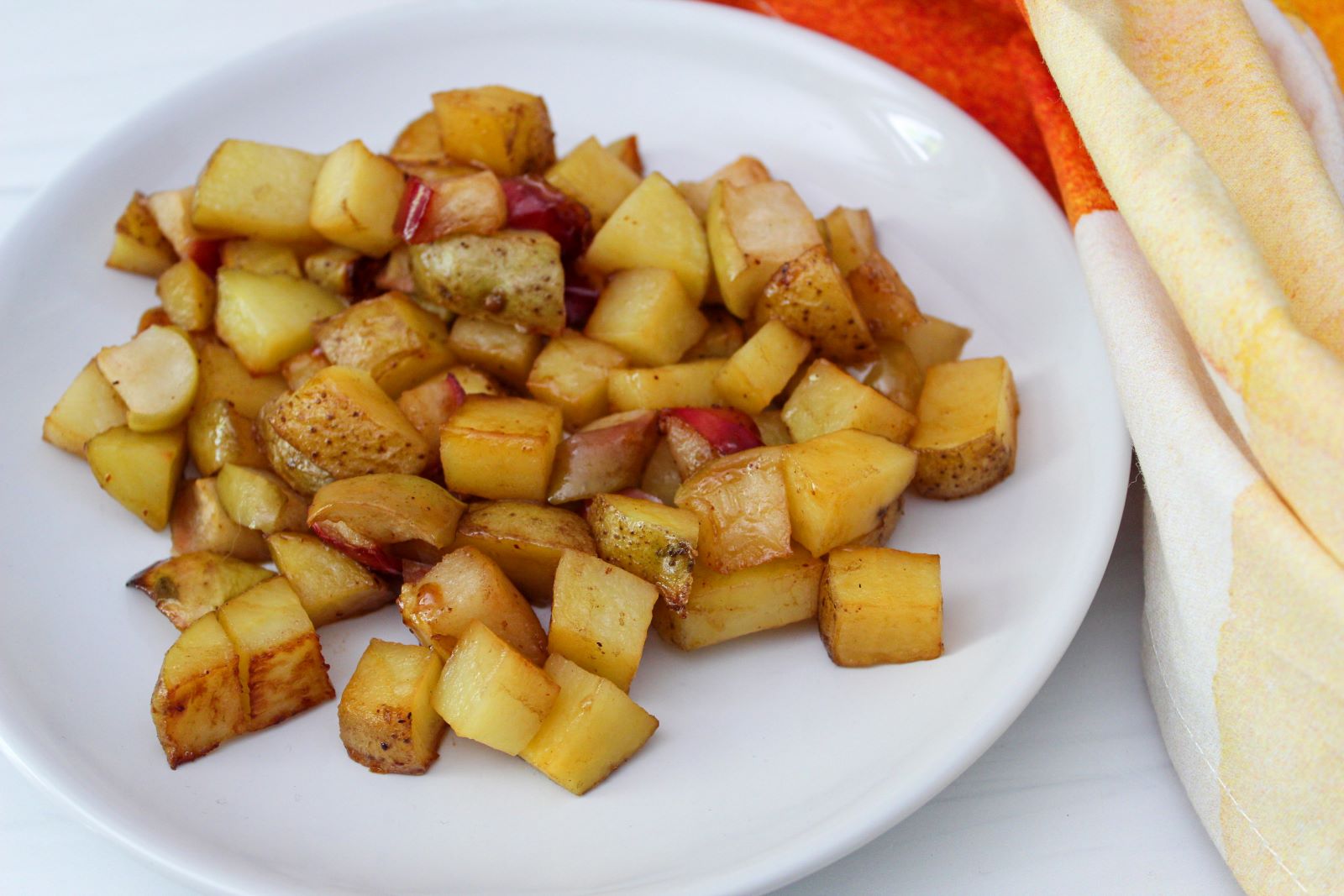honey chipotle roasted potatoes and apples on plate 1