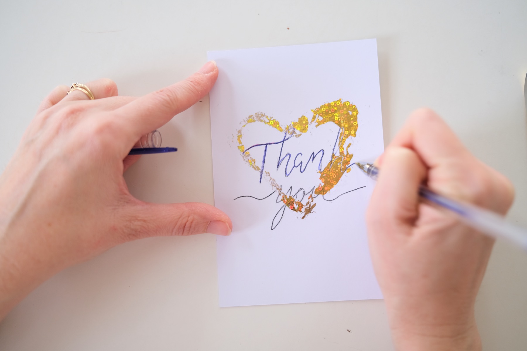 write thank you with a gel pen