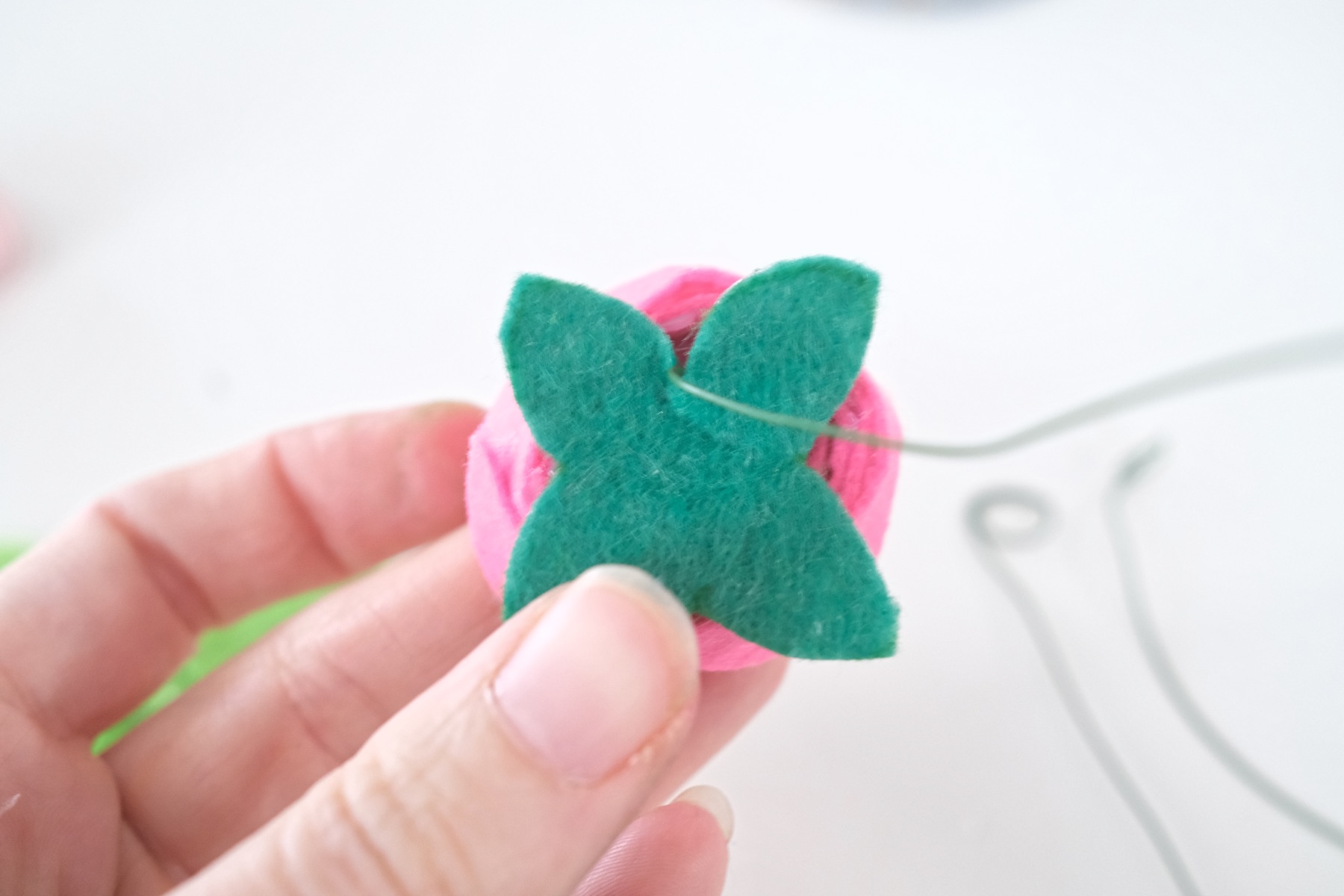 attach the leaves to the bottom of the felt flower