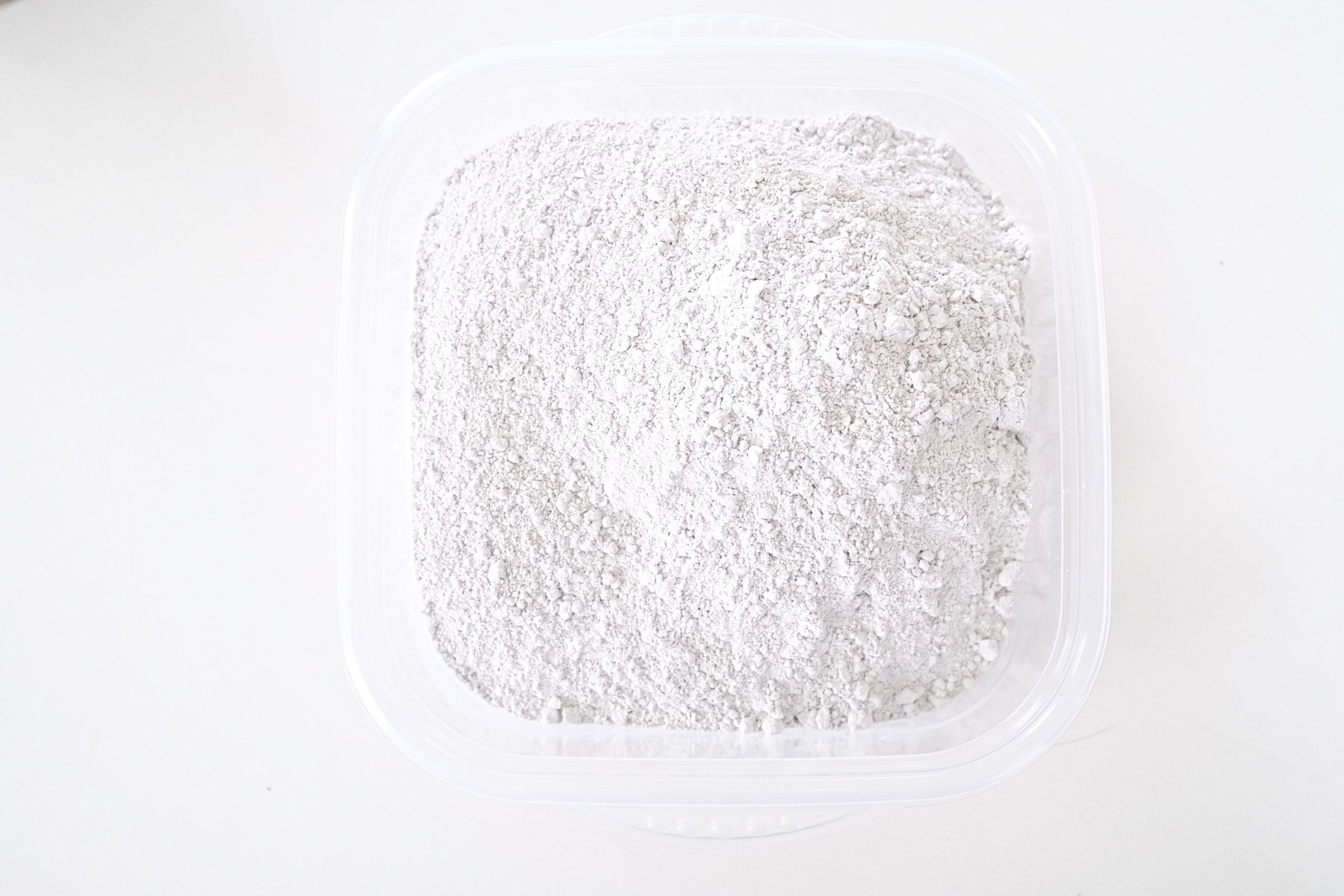 pour the dry concrete powder into a container