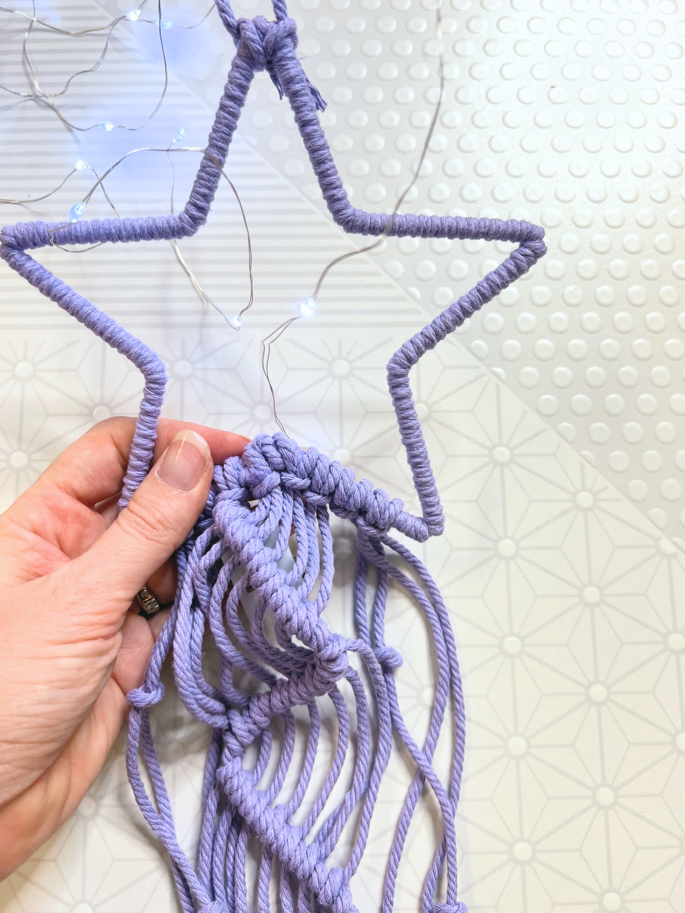 add string lights to the star macrame wall hanging