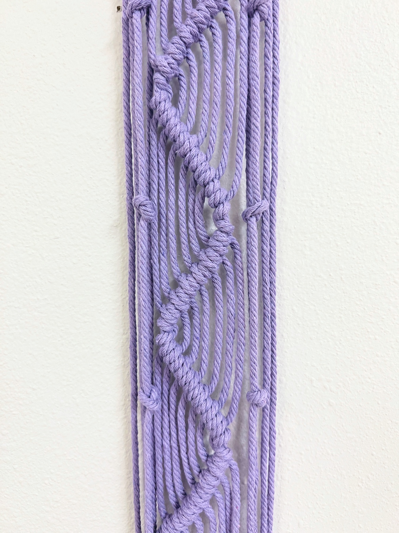 knots along the sides of the macrame hanging