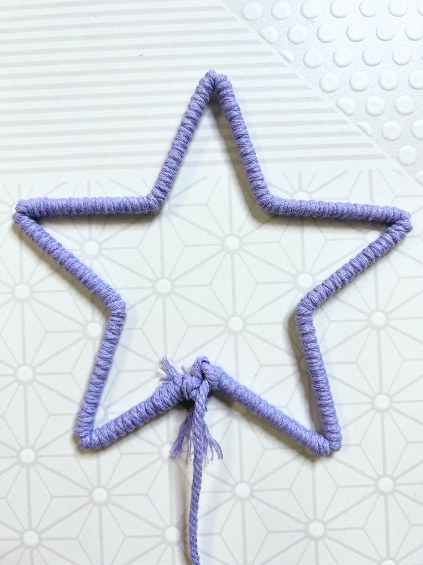 star macrame base wrapped before extra cord is cut