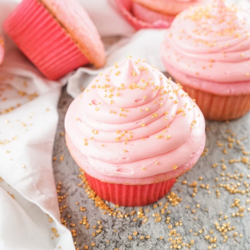frosting-the-pink-champagne-cupcakes-with-gold-sprinkles-square
