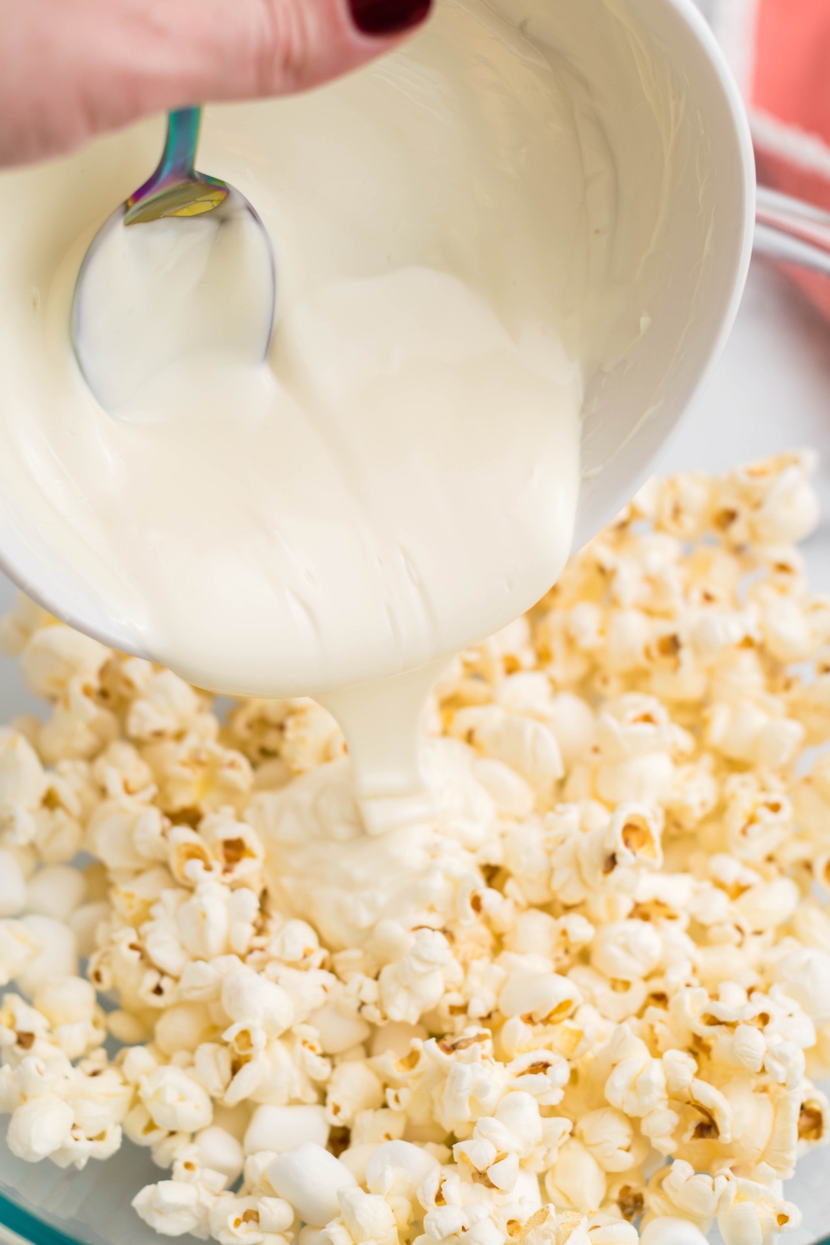 pour white chocolate over the popcorn
