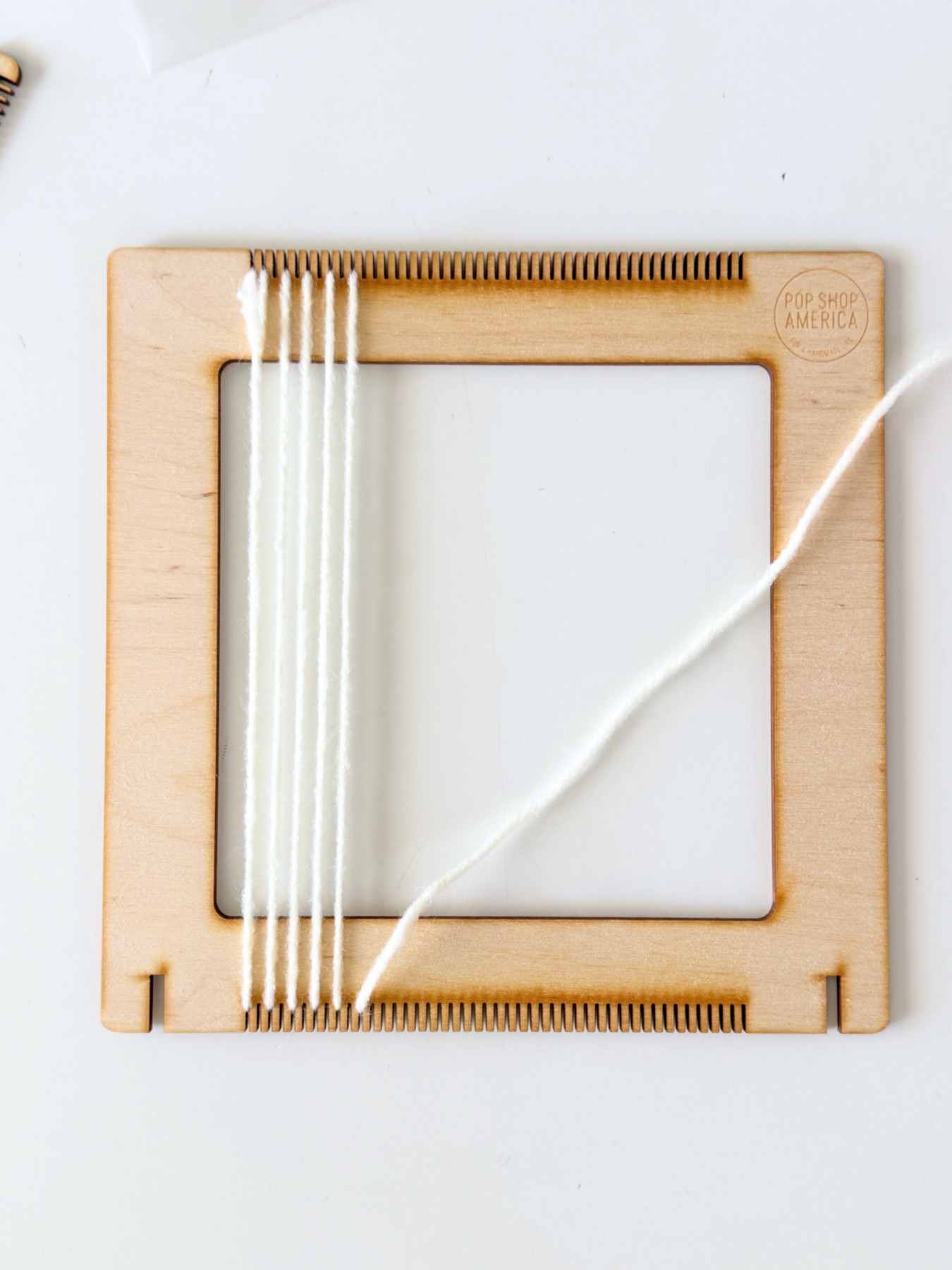 adding the warp to the loom web