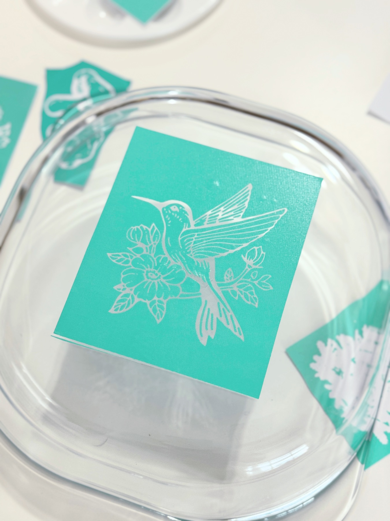 placing a sticker stencil on a glass pan